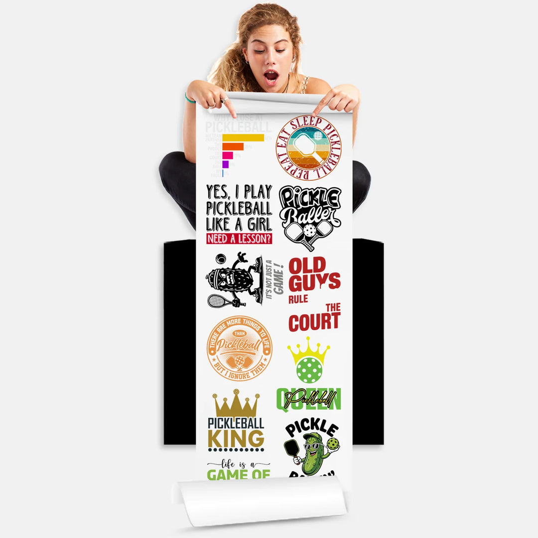 Person holding pickleball DTF transfers gang sheet with 11 funny pickleball designs including Eat Sleep Pickleball slogans