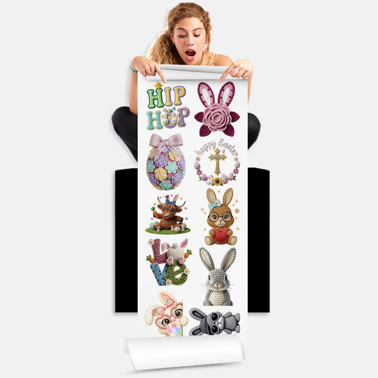 Person holding Easter DTF transfer gang sheet with 10 crochet yarn style bunny and egg designs ready to press on clothing