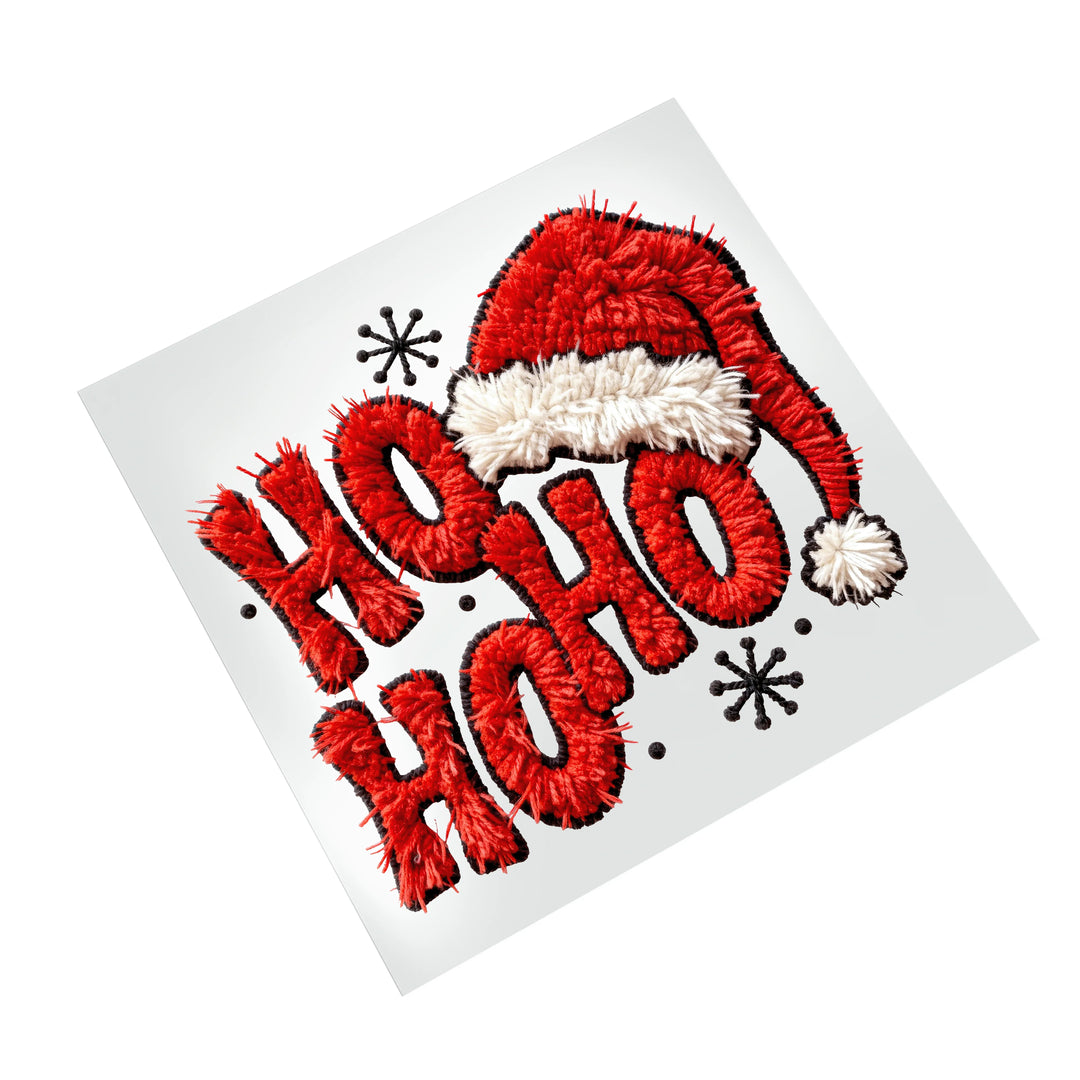 Christmas DTF transfer featuring red Ho Ho Ho lettering with Santa hat and white pom pom holiday design ready to press