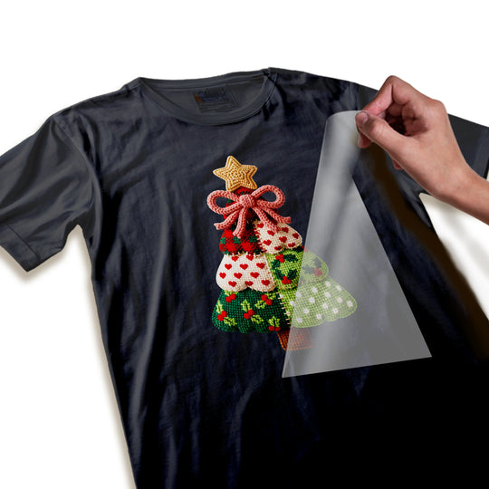 Close-up detail of knitted Christmas tree DTF transfer showing intricate crochet patterns, star, and bow elements