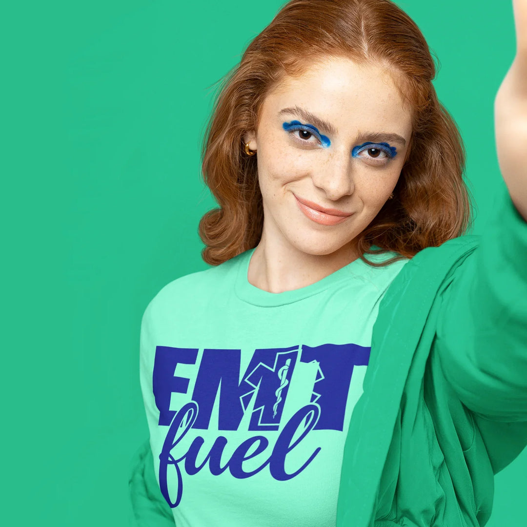 Person wearing EMT Fuel DTF transfer design on navy t-shirt showing emergency medical services pride