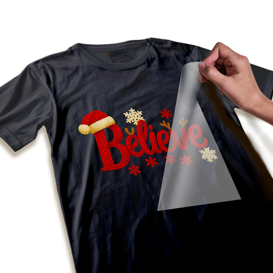 Close-up detail of Christmas Believe DTF transfer showing knitted texture, Santa hat trim and snowflake details