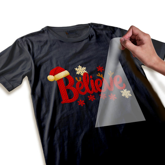 Close-up detail of Christmas Believe DTF transfer showing knitted texture, Santa hat trim and snowflake details