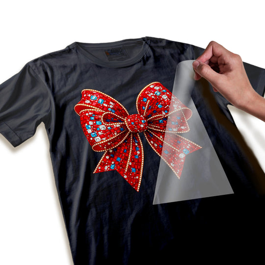 Close-up detail of Christmas bow DTF transfer showing individual rhinestone and crystal embellishments