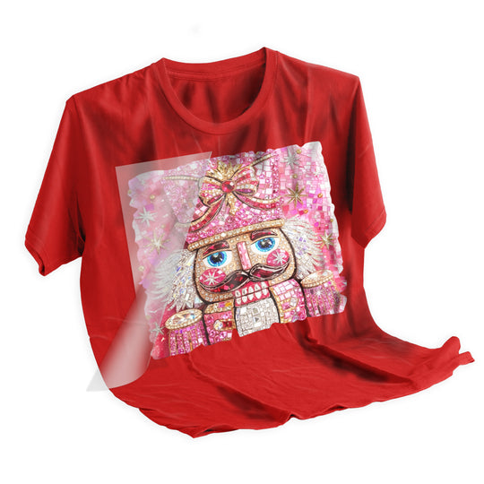 Pink rhinestone nutcracker Christmas DTF transfer heat pressed onto dark holiday t-shirt showing final application result