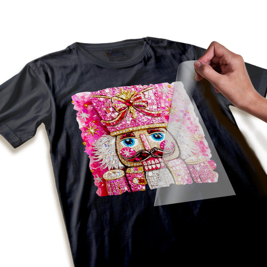 Close-up detail view of rhinestone and sequin embellishments on pink nutcracker Christmas DTF transfer showing texture and sparkle