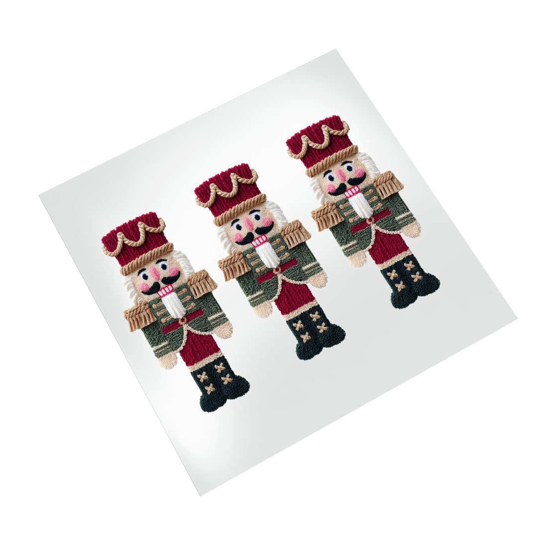 Christmas nutcracker DTF transfer on white background displaying three detailed nutcracker figures with crowns and holiday uniforms