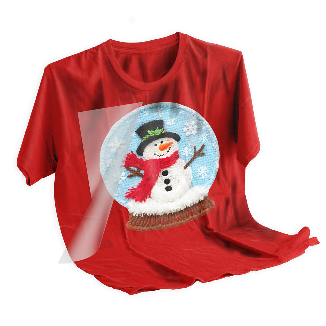 Christmas snowman snow globe DTF transfer applied to dark colored t-shirt showing final pressed result and design placement
