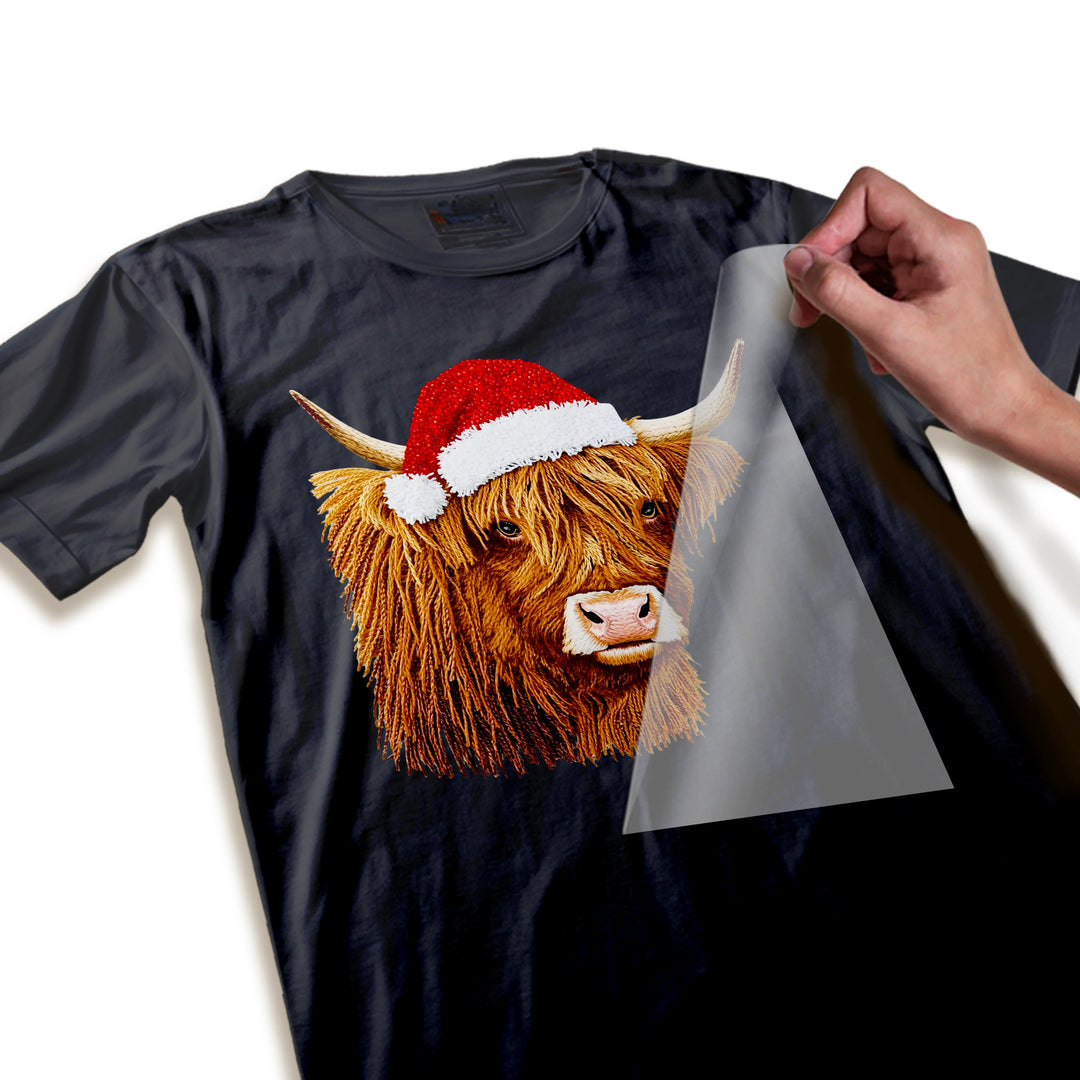 Close-up detail shot of Christmas Highland cow DTF transfer showing fur texture and Santa hat sparkle details