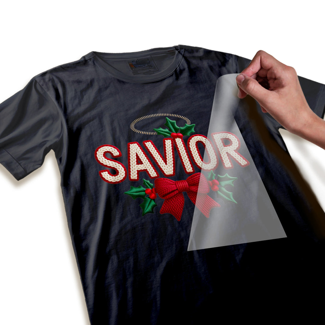 Close-up detail of Christmas SAVIOR DTF transfer showing intricate knit texture, burgundy bow weave pattern, and holly leaf vein details