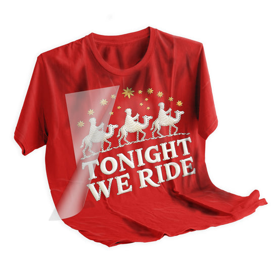 Christmas wise men DTF transfer applied to dark colored t-shirt showing final pressed result with gold stars and camel design