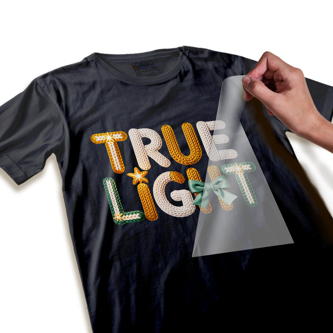 Close-up detail of True Light DTF transfer showing realistic knitted yarn texture, snowflake accents, and dimensional rope-like letter construction