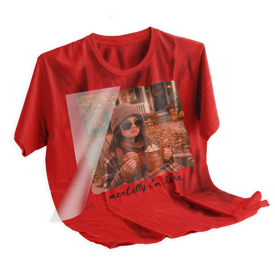 Heat press application of Mentally I'm Here fall DTF transfer being pressed onto a rust orange t-shirt with clamshell heat press at 310 degrees Fahrenheit