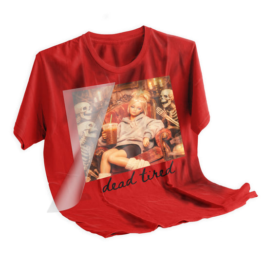 Heat press being applied to a black t-shirt using the Halloween Dead Tired Retro Doll DTF transfer showing proper application technique and placement