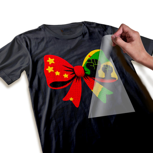 Close-up detail shot of Black History fist bow DTF transfer showing textured yarn-like surface quality, raised fist details, star accents, and color transitions in the bow design