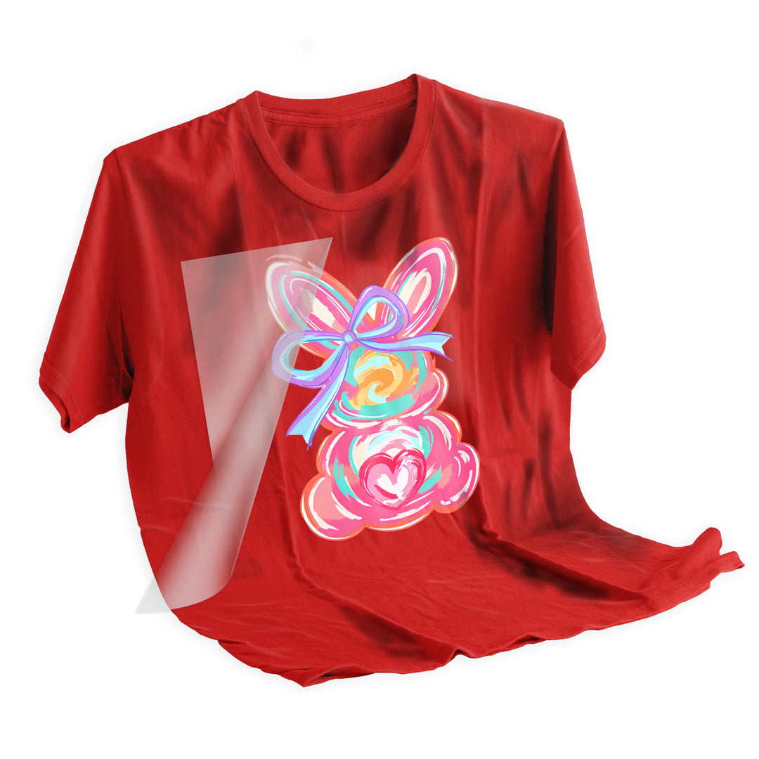 Applied Easter bunny DTF transfer on fabric showing final pressed result with vibrant watercolor bunny design and purple bow details