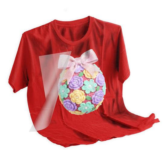 Easter DTF transfer applied to light colored t-shirt showing the crochet floral egg design with dimensional texture and vibrant spring colors