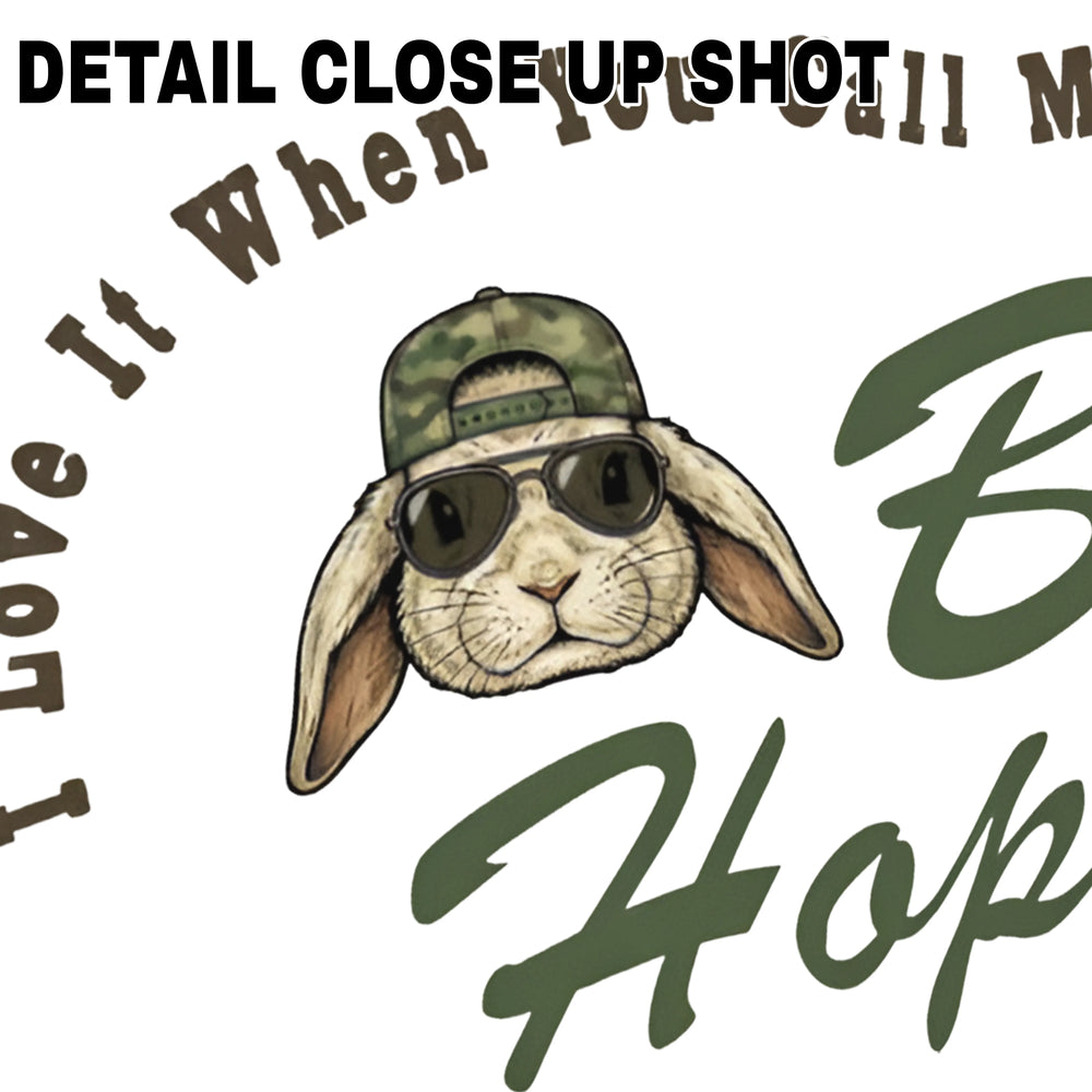 Easter DTF transfer design showing cartoon bunny wearing camouflage baseball cap and sunglasses with text I Love It When You Call Me Big Hoppa
