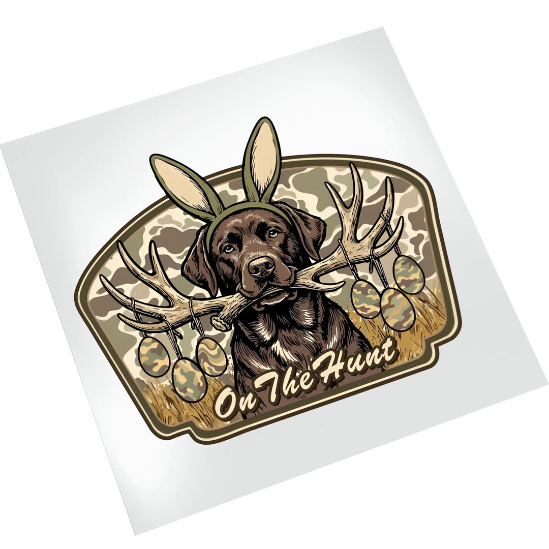 Easter hunting dog DTF transfer on white background showing chocolate lab with bunny ears, antlers, and camouflage elements ready to press