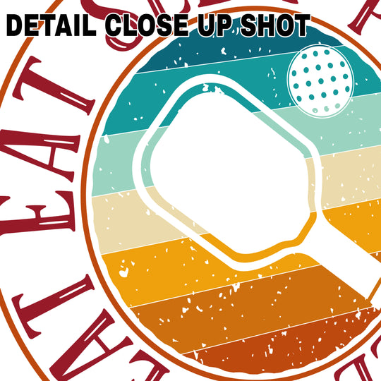 Pickleball DTF transfer featuring vintage circular badge design with paddle silhouette, ball graphic, and 'Eat Sleep Pickleball Repeat' text in retro sunset gradient colors