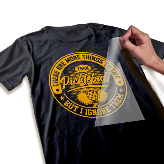 Close-up detail of pickleball DTF transfer showing orange vintage badge texture with paddle graphics and decorative elements