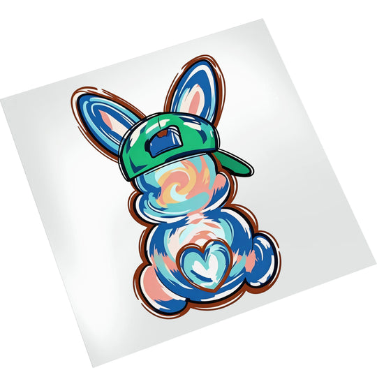 Easter bunny DTF transfer with tie-dye swirl patterns displayed on white mockup background showing vibrant colors and baseball cap detail