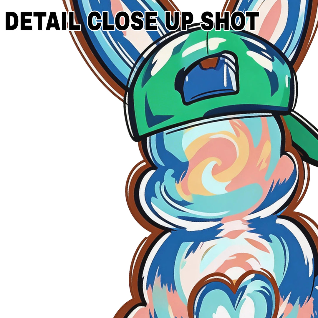 Colorful tie-dye bunny wearing green baseball cap DTF transfer design with swirling rainbow patterns and heart detail on white background