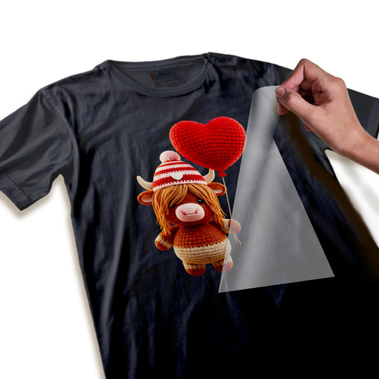 Close-up detail of Valentine highland cow DTF transfer showing textured yarn-like beanie pattern and smooth heart balloon finish